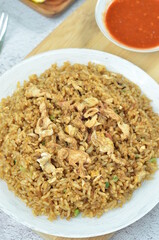 Delicious fried rice with egg, chilli, crackers and green onion, Indonesian dish.