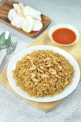 Delicious fried rice with egg, chilli, crackers and green onion, Indonesian dish.