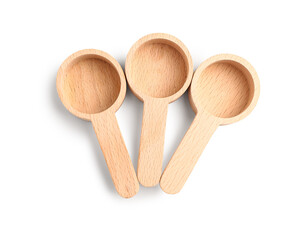 Empty wooden scoops on white background