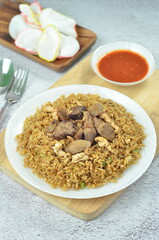 Delicious beef fried rice with egg, chilli, crackers and green onion, Indonesian dish.