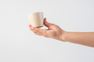 Coffee in a white cup and hand, coffee in a glass, cup on white background