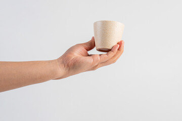 Coffee in a white cup and hand, coffee in a glass, cup on white background
