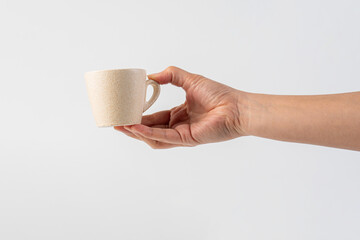 Coffee in a white cup and hand, coffee in a glass, cup on white background