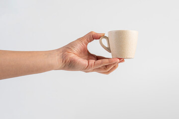 Coffee in a white cup and hand, coffee in a glass, cup on white background