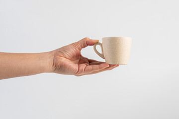 Coffee in a white cup and hand, coffee in a glass, cup on white background