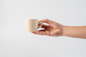 Coffee in a white cup and hand, coffee in a glass, cup on white background