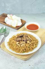 Delicious beef fried rice with egg, chilli, crackers and green onion, Indonesian dish.