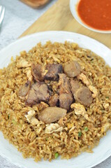 Delicious beef fried rice with egg, chilli, crackers and green onion, Indonesian dish.