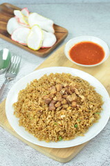 Delicious chicken fried rice with egg, chilli, crackers and green onion, Indonesian dish.