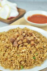 Delicious chicken fried rice with egg, chilli, crackers and green onion, Indonesian dish.