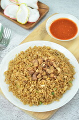 Delicious chicken fried rice with egg, chilli, crackers and green onion, Indonesian dish.