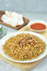 Delicious chicken fried rice with egg, chilli, crackers and green onion, Indonesian dish.