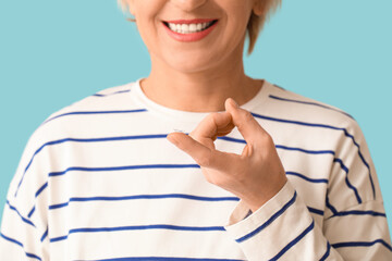 Mature woman with contact lens on blue background