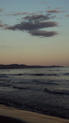 Sunset Over Calm Sea and Distant Hills