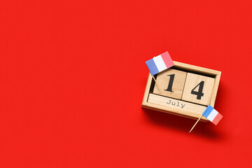 Cube calendar with date 14 JULY and French flags on red background. Bastille Day celebration