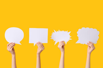 Female hands with different speech bubbles on yellow background