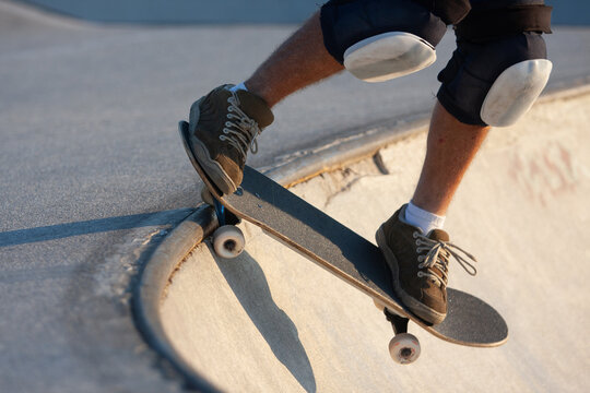 Close-up of skateboarder performing trick with protective gear