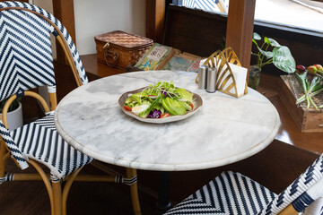 Fresh salad with avocado and tomatoes on a plate