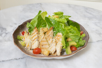 Fresh chicken and vegetable salad served on a plate