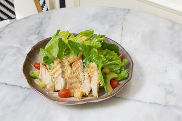 Fresh chicken and vegetable salad served on a plate