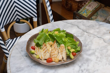 Fresh chicken and vegetable salad served on a plate