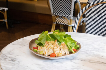Fresh chicken and vegetable salad served on a plate
