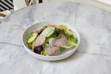 Fresh salad served in a glass bowl