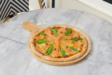 Baked pizza with smoke salmon and melted cheese casserole