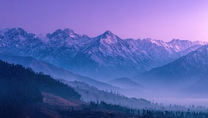 Panoramic view of snow-capped mountains at dawn, layers of hills and valleys shrouded in a purple-blue mist