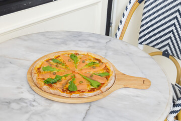 Baked pizza with smoke salmon and melted cheese casserole