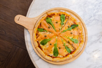 Baked pizza with smoke salmon and melted cheese casserole