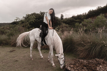 Young Woman Riding White Horse in Lush Green Nature Background