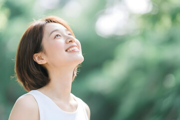 Smiling Asian Woman Embracing Nature and Wellness