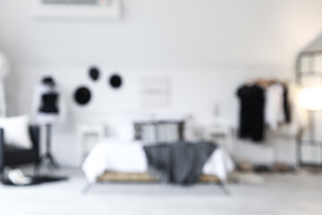 Rack with clothes and mannequin in interior of bedroom. Blurred view