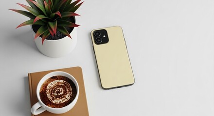 Modern workspace setup with phone, coffee, and plant