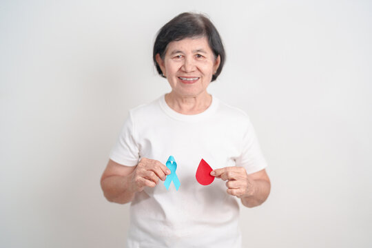 Elderly woman with Blue ribbon and red Blood drop for World Diabetes Day, Blue November Health, Prostate Cancer awareness, Blood sugar check, Insulin, Glucose screening, donation and Health checkup - Powered by Adobe