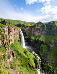 Majestic waterfall in lush green valley