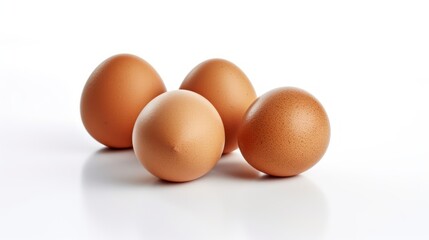 Four brown eggs on a white background