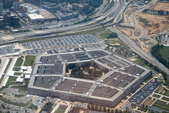 Aerial view of the Pentagon complex with surrounding roads, parking and greenery. g.