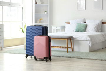 Suitcases on floor in hotel room interior