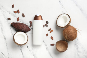Natural shampoo with coconut and cacao beans on light background
