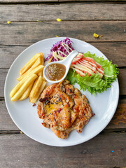 Grilled Chicken Steak with French Fries and Fresh Salad on White Plate
