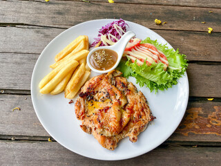 Grilled Chicken Steak with French Fries and Fresh Salad on White Plate
