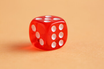 Red game dice on orange background