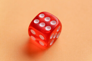 Red game dice on orange background