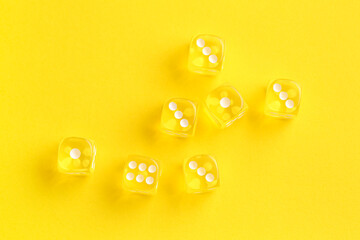 Yellow game dices on color background