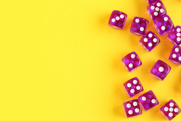 Purple game dices on yellow background