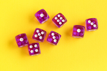 Purple game dices on yellow background