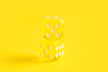 Yellow game dices on color background