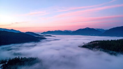 Obraz premium Misty mountain landscape at dawn.